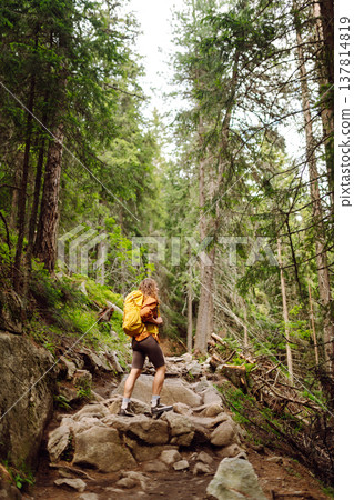 Young woman with backpack traveling outdoors. Hiking, active lifestyle. Young woman with backpack traveling outdoors. Hiking, active lifestyle. 137814819