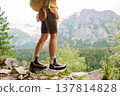 Close-up of female legs in hiking boots on a hiking trail. Travel, vacation. The concept of nature. 137814828