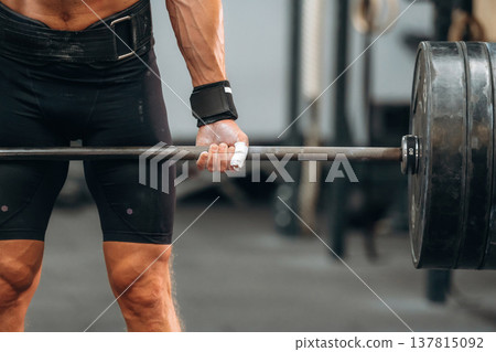 Close up view of athletic man that is lifting heavy barbell Close up view of athletic man that is lifting heavy barbell 137815092