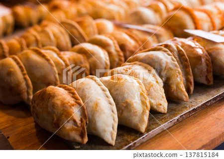 freshly baked empanadas with different fillings for sale 137815184
