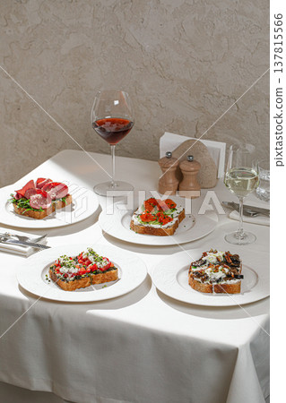 Assorted gourmet bruschetta with wine on table 137815566