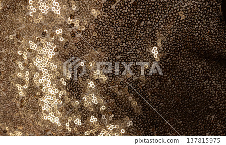 Golden wavy fabric for wallpaper.Textile texture with gold and bronze sequins.Metallic glitter and shadows 137815975