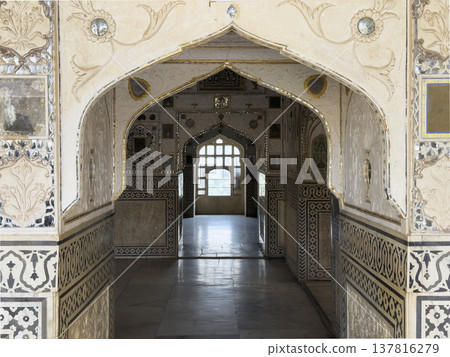 Jaipur palace interior features ornate arch corridor with mirror mosaic and decorative pattern. 137816279
