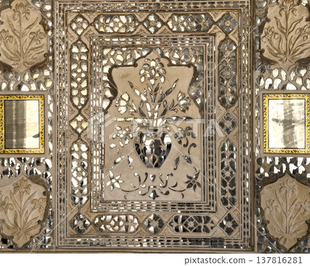 Jaipur palace wall features intricate mirror mosaic with floral ornament and geometric pattern. 137816281