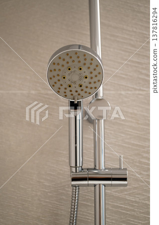 Modern chrome shower head with handheld hose and adjustable wall mount, providing comfort and versatility for daily bathroom hygiene and personal care Modern chrome shower head with handheld hose and adjustable wall mount, providing comfort and versatility for daily bathroom hygiene and personal care 137816294