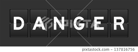 Black color analog flip board with word danger on gray background 137816756