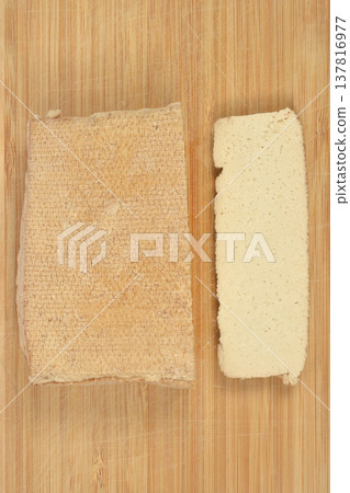 Top view of smoked tofu block and slice on wooden board Top view of smoked tofu block and slice on wooden board 137816977