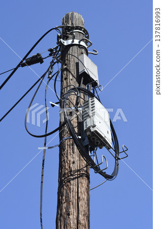 Wooden Utility Pole with Telecommunication Equipment Wooden Utility Pole with Telecommunication Equipment 137816993