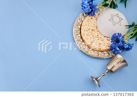 Passover seder plate with matzah, kippah, and kiddush cup 137817368