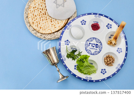 Seder plate with matzah, kippah, and wine cup preparing for passover 137817400