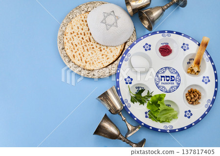 Passover seder plate with matzah, kippah, and silver cups Passover seder plate with matzah, kippah, and silver cups 137817405