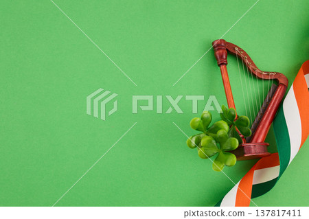 St. Patrick's day celebration with shamrocks, harp, and irish flag ribbon 137817411