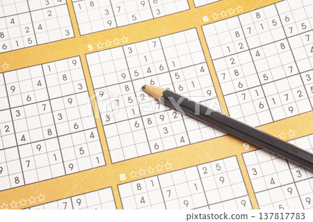 Sudoku puzzle game and pencil close up Sudoku puzzle game and pencil close up 137817783