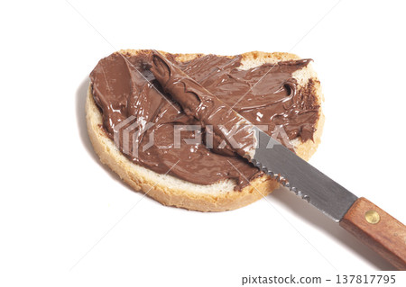 chocolate-nut paste spread on bread with knife, chocolate-nut paste spread on bread with knife, 137817795