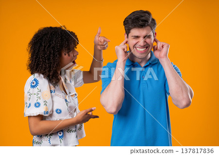 Angry Woman Yelling At Tired Man, He Covering Ears With Hands. Couple Burnout Angry Woman Yelling At Tired Man, He Covering Ears With Hands. Couple Burnout 137817836