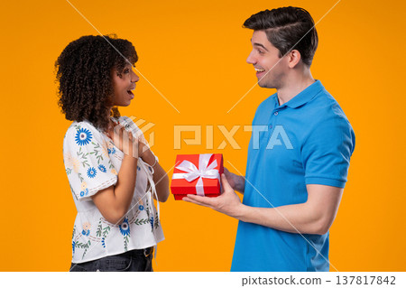 Young Man Gives Gift Box To Wife Or Girlfriend. Surprise, Unexpected Present Young Man Gives Gift Box To Wife Or Girlfriend. Surprise, Unexpected Present 137817842