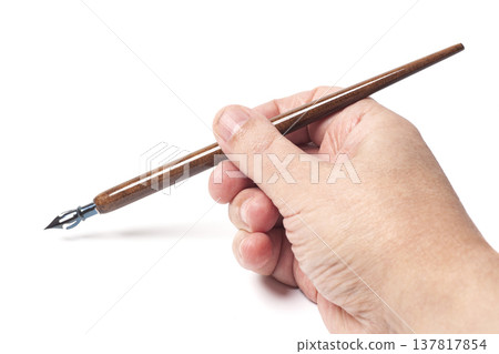 Fountain pen in hand isolated on white background. 137817854