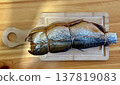 Cold hot smoked mackerel, beautifully laid out on a wooden chopping board, is ready for cooking and serving and is perfect for culinary themes. 137819083