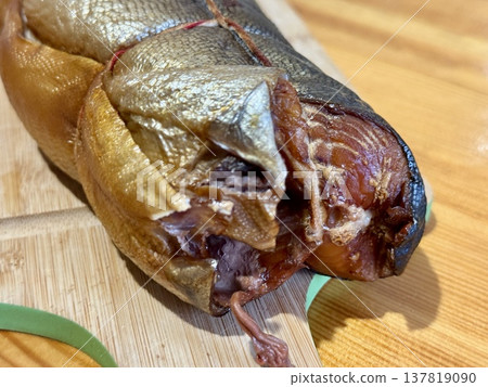 Cold hot smoked mackerel, beautifully laid out on a wooden chopping board, is ready for cooking and serving and is perfect for culinary themes. 137819090