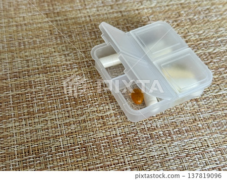 The weekly transparent pillbox is designed for convenient and efficient daily storage of dietary supplements and tablets. It has compartments with various types of capsules for administration. The weekly transparent pillbox is designed for convenient and efficient daily storage of dietary supplements and tablets. It has compartments with various types of capsules for administration. 137819096