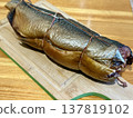 Cold hot smoked mackerel, beautifully laid out on a wooden chopping board, is ready for cooking and serving and is perfect for culinary themes. 137819102