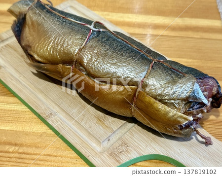 Cold hot smoked mackerel, beautifully laid out on a wooden chopping board, is ready for cooking and serving and is perfect for culinary themes. Cold hot smoked mackerel, beautifully laid out on a wooden chopping board, is ready for cooking and serving and is perfect for culinary themes. 137819102