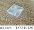 The weekly transparent pillbox is designed for convenient and efficient daily storage of dietary supplements and tablets. It has compartments with various types of capsules for administration. 137819120