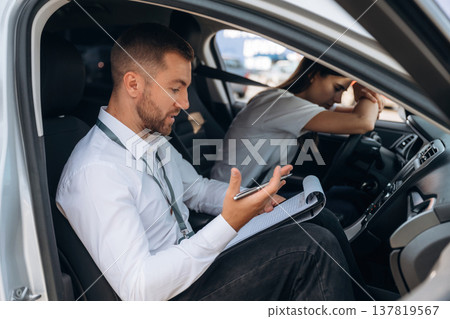 Disappointed, failure. Woman is with instructor in car, driving school concept 137819567