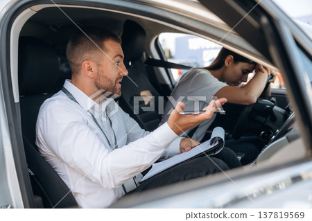 Disappointed, failure. Woman is with instructor in car, driving school concept 137819569
