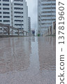 A rain-soaked bridge and apartment buildings 137819607