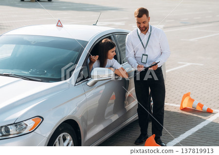 Woman is trying to pass exam in the driving school 137819913
