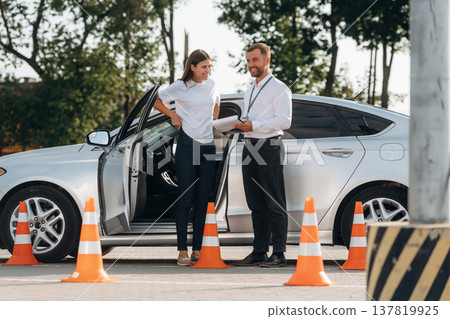 Discussing the results. Woman is trying to pass exam in the driving school 137819925
