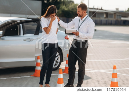 Sad, didn't pass the test. Woman is trying to pass exam in the driving school Sad, didn't pass the test. Woman is trying to pass exam in the driving school 137819934