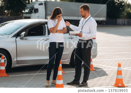 Sad, didn't pass the test. Woman is trying to pass exam in the driving school Sad, didn't pass the test. Woman is trying to pass exam in the driving school 137819935