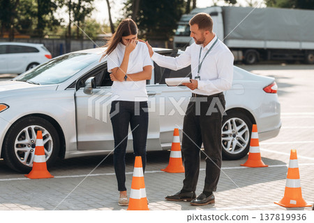 Sad, didn't pass the test. Woman is trying to pass exam in the driving school Sad, didn't pass the test. Woman is trying to pass exam in the driving school 137819936