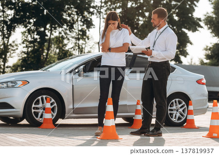 Sad, didn't pass the test. Woman is trying to pass exam in the driving school Sad, didn't pass the test. Woman is trying to pass exam in the driving school 137819937