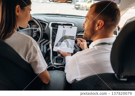 Visual tests. Woman is with instructor in car, driving school concept Visual tests. Woman is with instructor in car, driving school concept 137820079