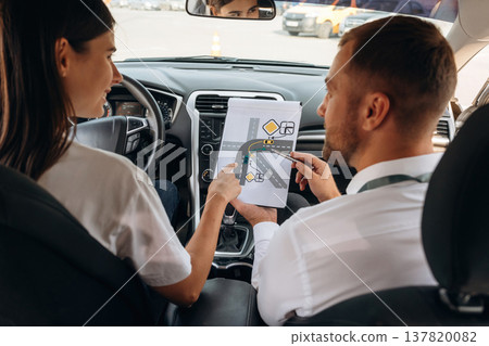 Picture, the theoretical test. Woman is with instructor in car, driving school concept 137820082