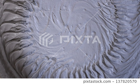 thick gray mortar with a circular ribbed pattern on a soft surface, creating an abstract textured empty background, is a mixture of building materials such as putty or plaster with a beautiful texture thick gray mortar with a circular ribbed pattern on a soft surface, creating an abstract textured empty background, is a mixture of building materials such as putty or plaster with a beautiful texture 137820570
