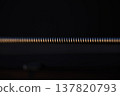 Extreme Macro Close-Up of a Metallic Winding Guitar String on a Dark Background 137820793