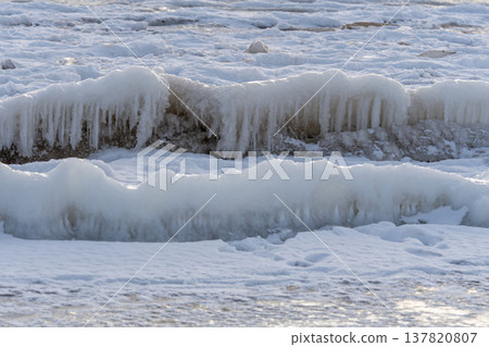 Ice formations on the shoreline during winter time in a cold coastal area 137820807