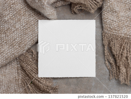 Blank card mockup on grey stone and beige blanket, copy space. Minimal rustic stationery template 137821520