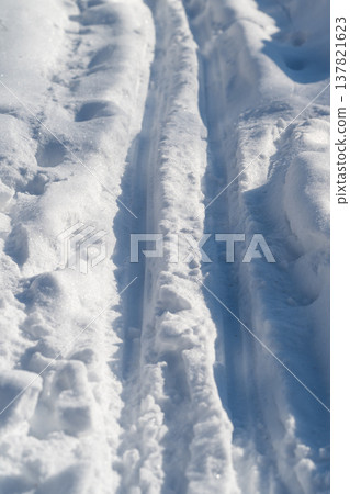 Snowy trails showcase natural harmony. Beautiful snowy terrain with peaceful and balanced vibe. Immaculate snowcovered paths evoke health and tranquil outdoor living 137821623