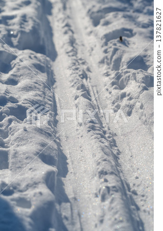 Frosted snow path with shimmering crystal highlights. Bright icy ski trail with detailed crystal reflections capturing peaceful outdoor moments and reflective moods Frosted snow path with shimmering crystal highlights. Bright icy ski trail with detailed crystal reflections capturing peaceful outdoor moments and reflective moods 137821627