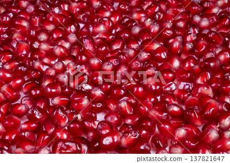 Scattered pomegranate seeds on clean white surface, vibrant red contrast, crisp highlights, evokes wellness and clean eating, ideal for recipe or smoothie visuals Scattered pomegranate seeds on clean white surface, vibrant red contrast, crisp highlights, evokes wellness and clean eating, ideal for recipe or smoothie visuals 137821647