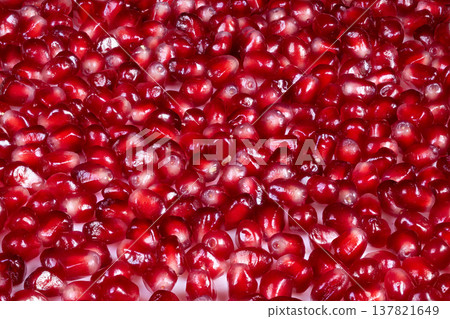 Lustrous pomegranate kernels showcase health benefits vividly. Lively photograph capturing juicy pomegranate seeds bursting with essential nutrients and vibrant hues Lustrous pomegranate kernels showcase health benefits vividly. Lively photograph capturing juicy pomegranate seeds bursting with essential nutrients and vibrant hues 137821649