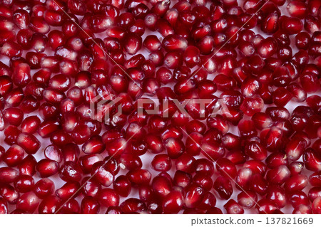 Abstract fruit seed pattern with dramatic lighting effects. Detailed macro image capturing artistic arrangement of pomegranate seeds with vivid colors and dynamic lighting Abstract fruit seed pattern with dramatic lighting effects. Detailed macro image capturing artistic arrangement of pomegranate seeds with vivid colors and dynamic lighting 137821669