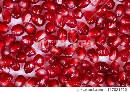 Bright colored seeds bursting flavor. Luminous crimson stones paired with lively taste. Brightly colored seeds with deliciously refreshing taste and vibrant visual appeal 137821730
