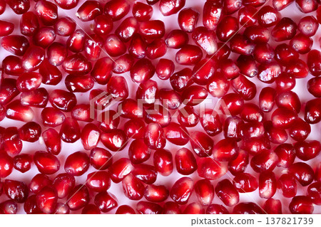 Vibrant pomegranate seeds rich in antioxidants, nutrientpacked snack concept, fresh red texture, flatlay composition for wellness branding, vitamin message and macro detail 137821739