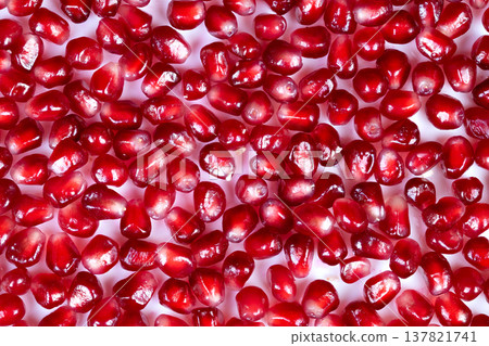 Closeup of ripened pomegranate seeds. Detailed closeup of mature pomegranate seeds visualization. Crisp and vibrant depiction of blossoming pomegranate seeds in detail 137821741